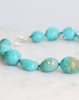 Turquoise Strand with silver barnacles and red thread