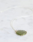Necklace with a green pendant on a white background