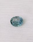 Blue gemstone on a white fabric background