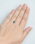 Greenish blue montana sapphire on hand