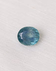 Blue gemstone on a white fabric background