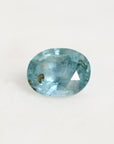 Blue sapphire with inclusion on a white background