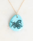 Necklace with a pendant featuring an octopus design on a light blue background