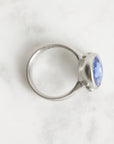 Silver ring with a blue gemstone on a white background