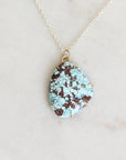 Turquoise stone necklace on a white background