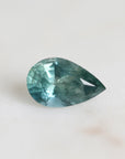 Green/blue pear shaped sapphire with inclusions