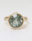 mossy aquamarine ring set in gold with silver barnacles