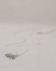 Necklace with a pendant on a light gray background