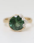 A 2.74ct tourmaline ring. The tourmaline is a deep green and is set in 14k gold with a 14k gold band. The rsetting is encrusted with bright sterling silver barnacles.