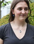 woman wearing Petrichor Variscite necklace outside