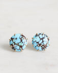 Turquoise stone earrings on a light gray background