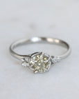 Silver ring with a diamond on a light gray background