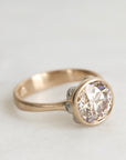 gold ring with a diamond and platinum barnacles against a white background
