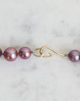 Pink pearl strand with lavender thread and gold barnacles