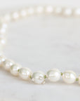Pearl necklace on a light gray background
