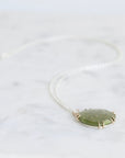 Green pendant necklace on a white background