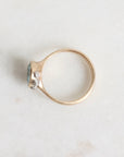 Gold ring with a gemstone on a light gray background