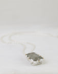 Necklace with a pendant on a light gray background