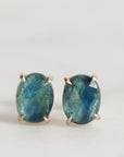 Pair of blue gemstone earrings on a light gray background