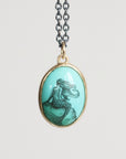 Mermaid pendant necklace on a light gray background