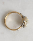 Gold ring with a diamond on a light gray background