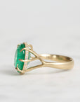 Large green gemstone ring with a diamond halo and branchy setting