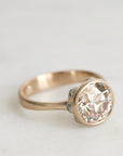 gold ring with a diamond and platinum barnacles against a white background