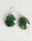 Green stone earrings with gold accents on a white background