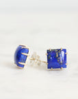 Pair of blue gemstone earrings on a white background