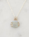 Opal pendant on marble background