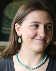 Woman wearing green earrings