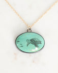 Necklace with a pendant featuring a turtle design on a light background