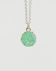 Necklace with a green pendant on a white background
