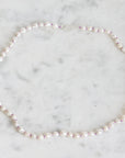 Pearl necklace on a marble surface