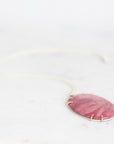 Large pink stone pendant set in gold prongs