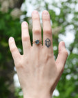 gold ring with blue gemstone on hand