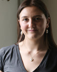 Woman wearing a gray shirt with a neutral background