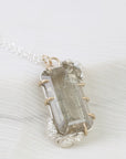 Crystal pendant necklace on a white fabric background