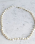 Pearl necklace on a marble surface