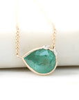 Teardrop-shaped green gemstone necklace on a white background