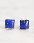 Pair of square blue gemstone earrings on a white background