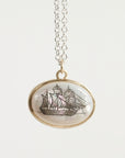 Necklace with a pendant featuring a ship design on a white background