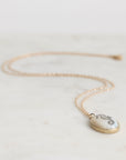 Necklace with a seahorse pendant on a light background