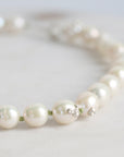 Pearl necklace on a light gray background