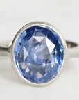 platinum ring with a blue gemstone on a white background