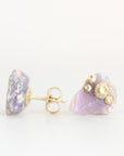 Raw opal studs with barnacle details in gold against a plain background.