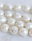 Pearl necklace with a silver clasp on a light background