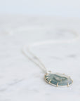 Necklace with a pendant on a light gray background