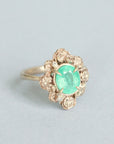 Green stone surrounded by golden rose setting