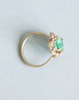 Green stone surrounded by golden rose setting